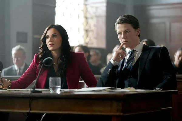 Two lawyers sit at a table in a courtroom in The Rainmaker.